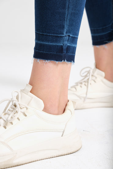 Dark wash skinny jeans on model — Clutch Denim