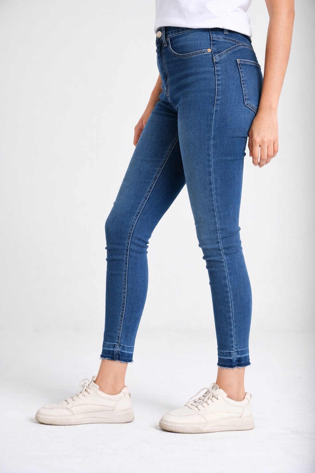 Raw-hem medium wash skinny jeans detail — Clutch Denim