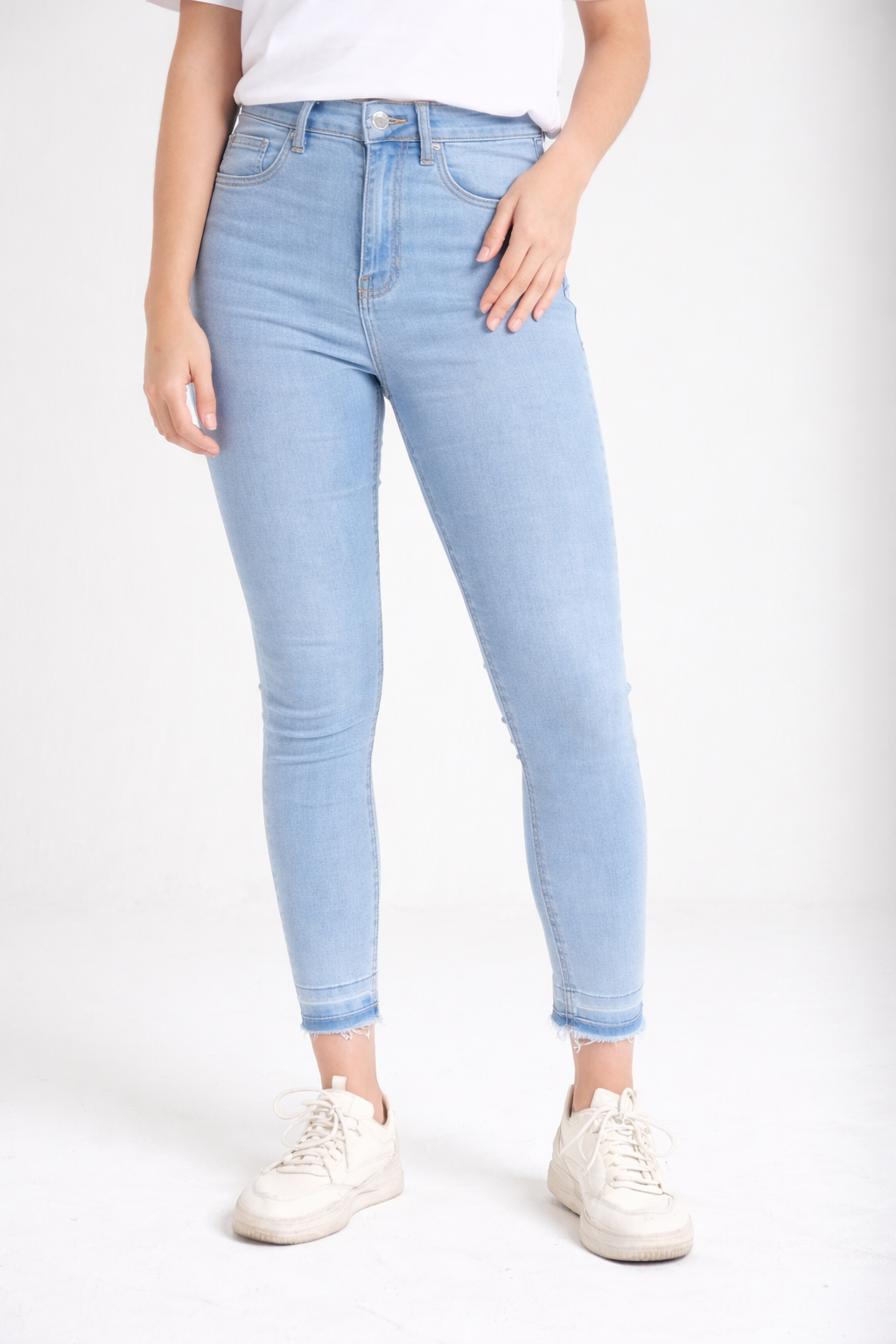 Raw-hem light wash skinny jeans detail — Clutch Denim
