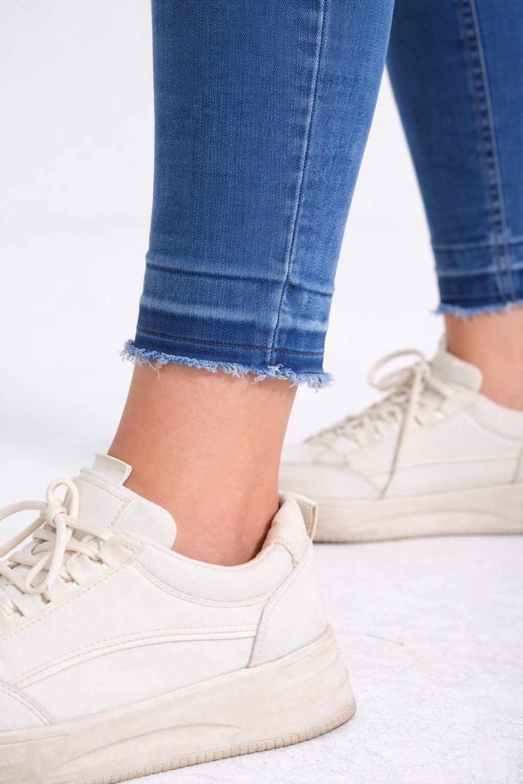 Medium wash raw-hem skinny jeans front view — Clutch Denim